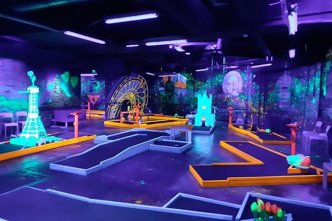 Prague Black Light Mini Golf and Games with free Drinks - Your one-stop plan: 18 holes, two drinks, and a relaxed pace
